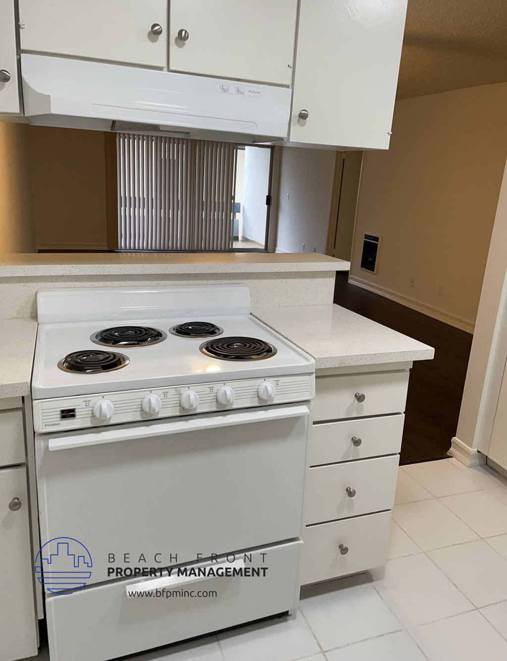 an empty kitchen with a stove and a counter